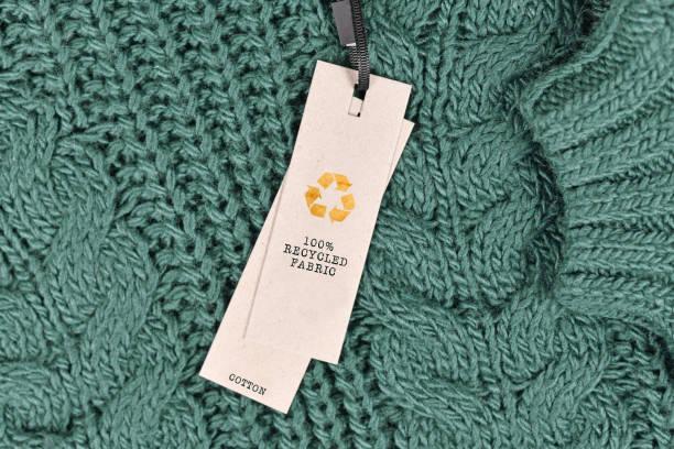 Up close image of a swing tag attached to a green sweater