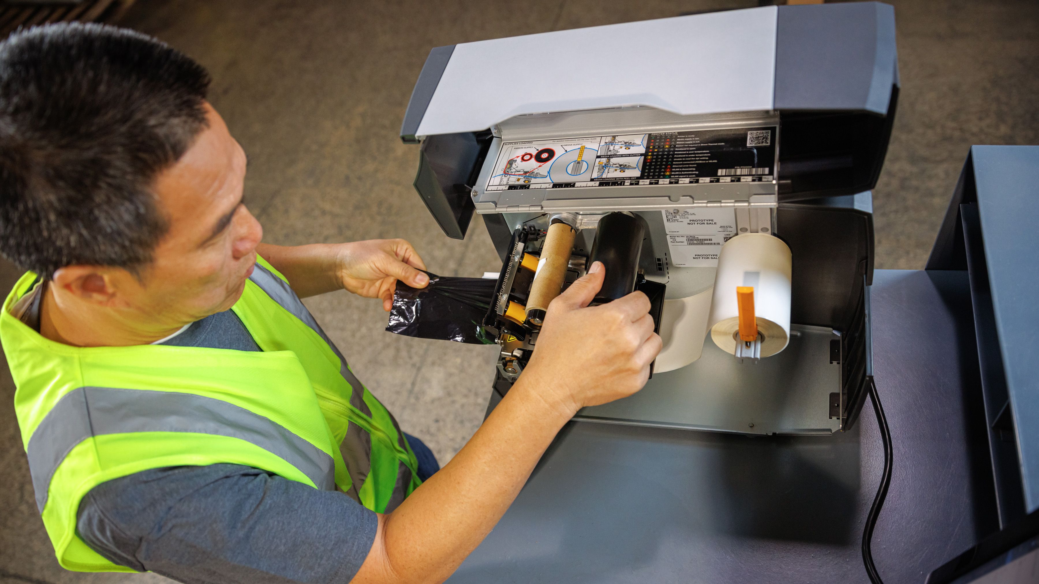 Man operating a thermal transfer printer